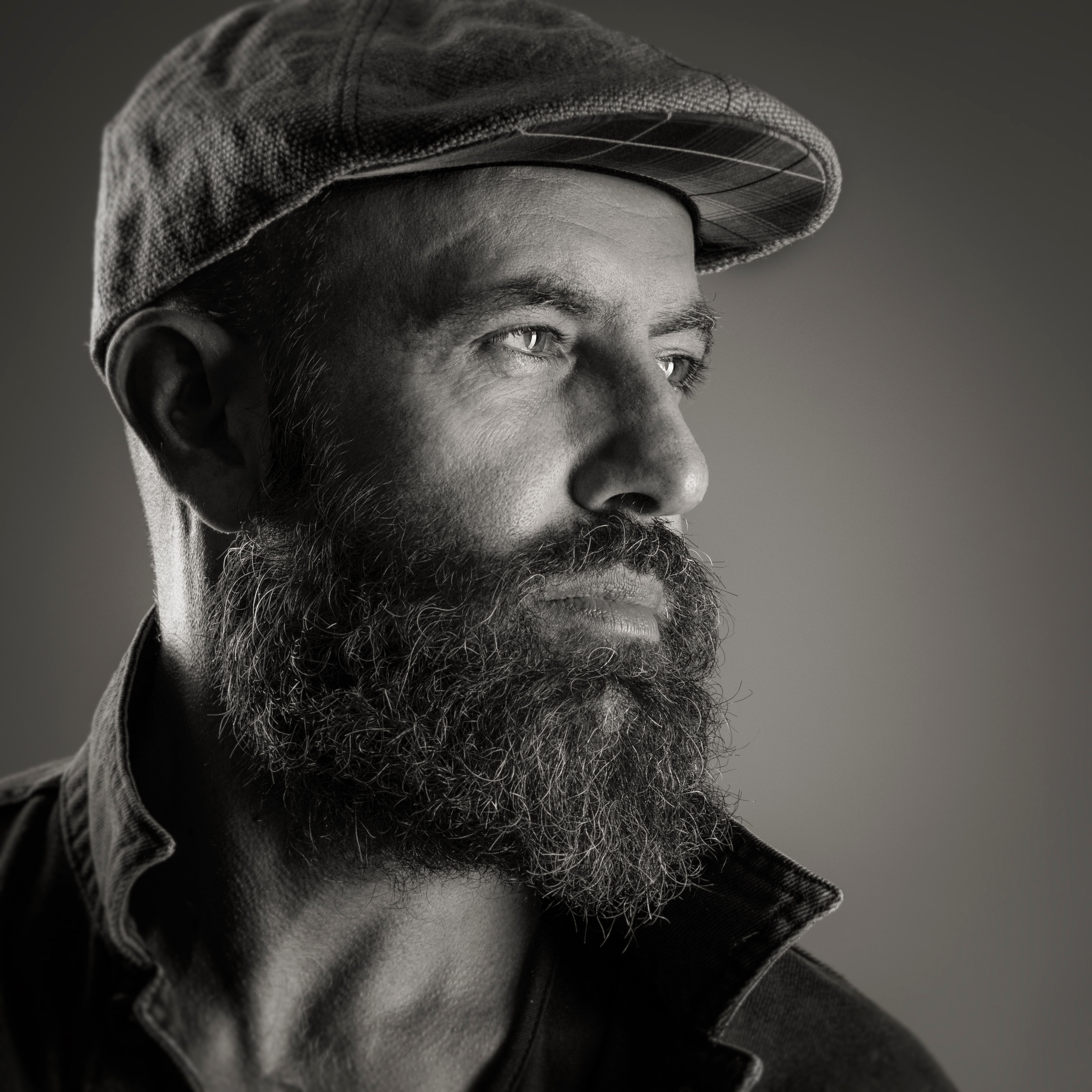 Man with full beard wearing cap